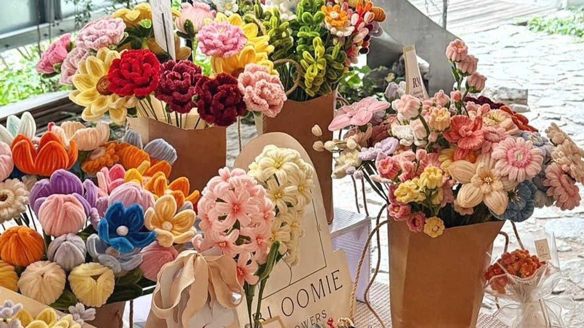 Colourful handmade chenille stem flowers displayed at Bloomie’s market stall