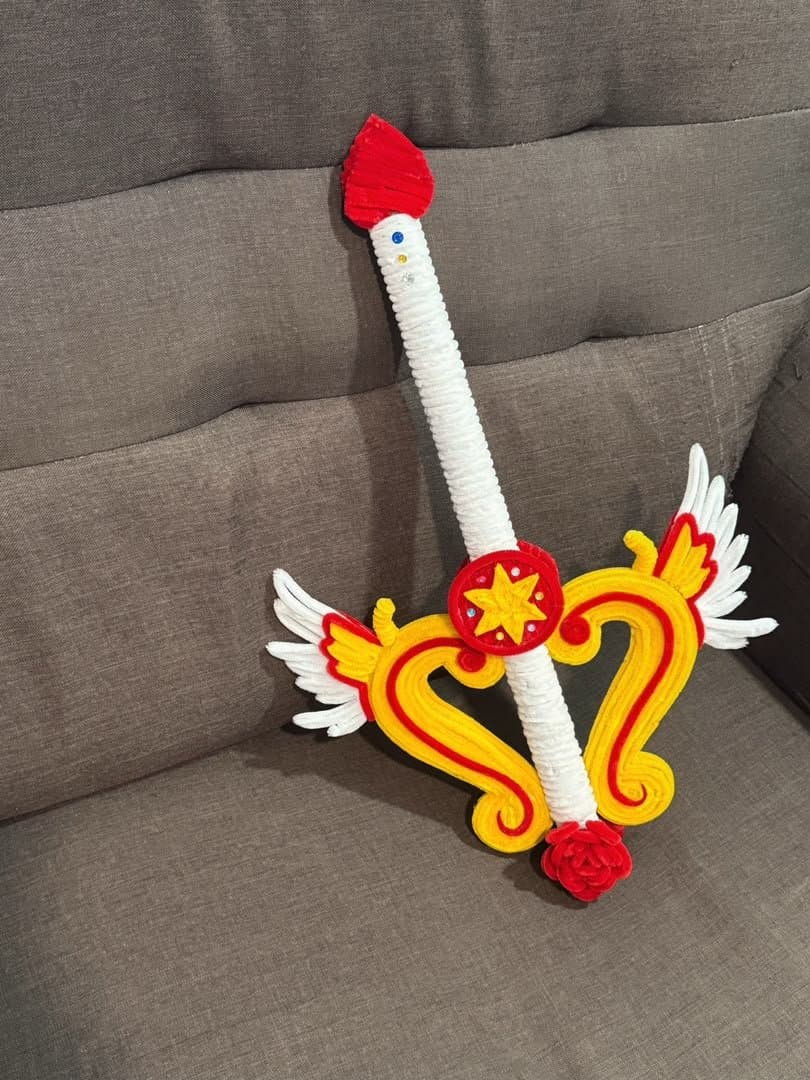 A decorative handmade sword in red, yellow and white chenille stems