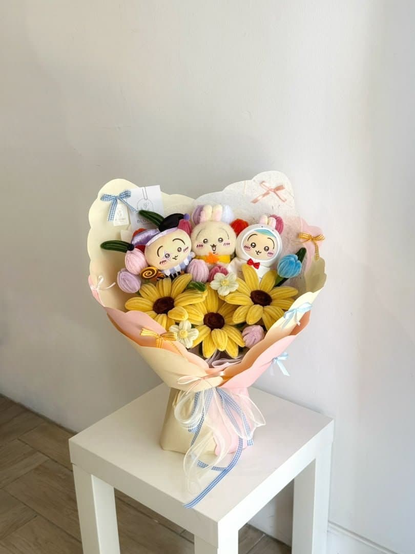 Plush characters arranged with handmade yellow flowers in a gift bouquet