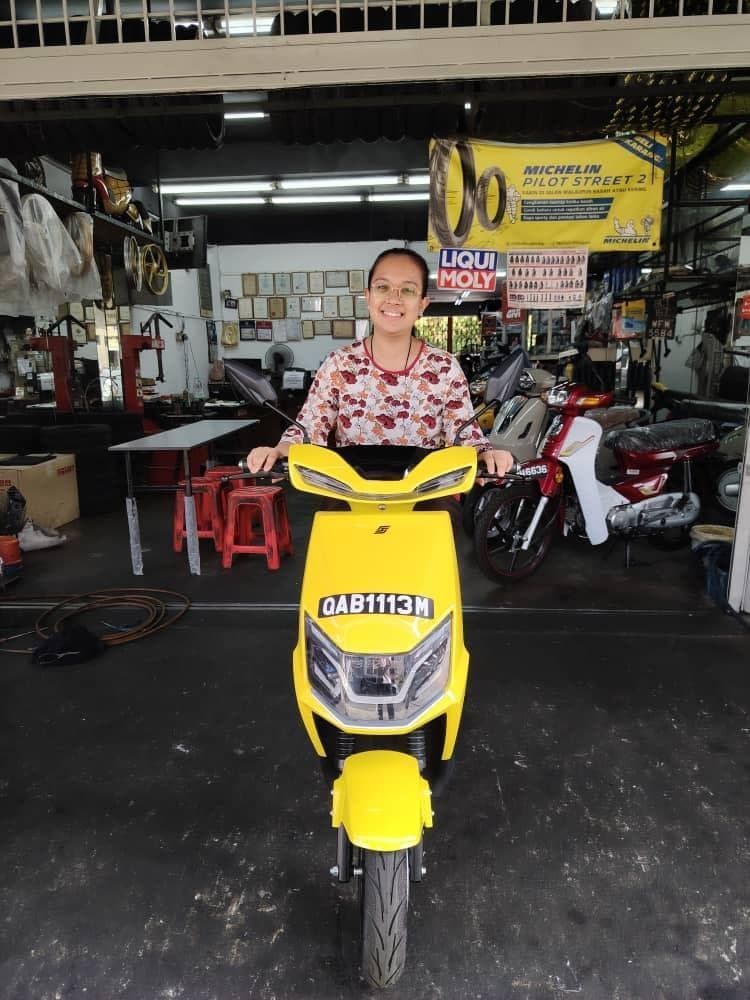 A yellow motorcycle displayed outside Hok Hing Motor