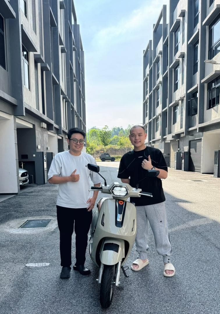 Two men standing beside a light-coloured motorcycle outdoors, as pictured in Hok Hing Motor’s company profile